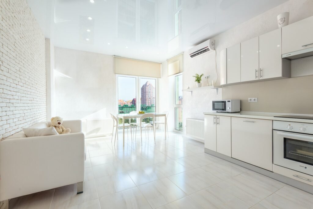 Modern kitchen with built in appliances and dining room